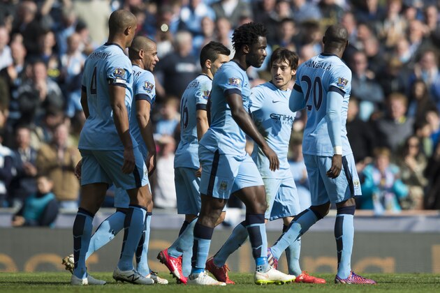 Manchester City's David Silva, second right, celebrates with teammates after scoring during the English Premier League soccer match between Manchester City and West Bromwich Albion at the Etihad Stadium, Manchester, England, Saturday March 21, 2015. (AP Photo/Jon Super)