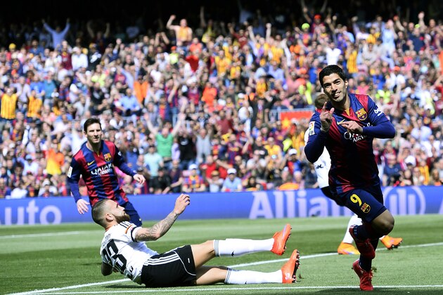 FC Barcelona's Luis Suarez, right, reacts after scoring against Valencia during a Spanish La Liga soccer match at the Camp Nou stadium in Barcelona, Spain, Saturday, April 18, 2015. (AP Photo/Manu Fernandez)