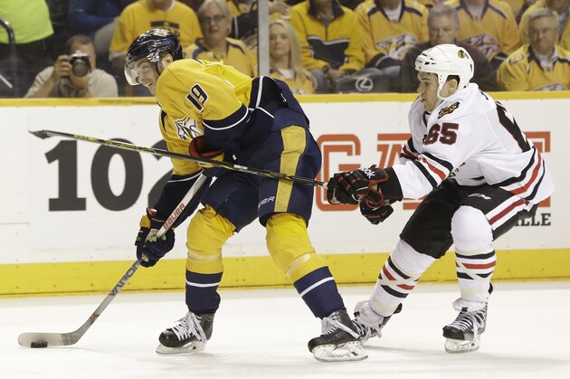Chicago Blackhawks center Andrew Shaw (65) tries to slow down Nashville Predators center Calle Jarnkrok (19), of Sweden, in the third period of Game 1 of an NHL Western Conference hockey playoff series Wednesday, April 15, 2015, in Nashville, Tenn. (AP Photo/Mark Humphrey)