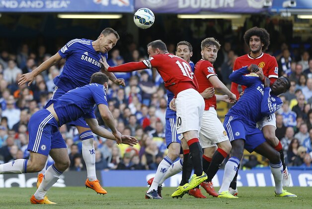 Chelsea's John Terry, left,  vies for the ball with Manchester United's Wayne Rooney during the English Premier League soccer match between Chelsea and Manchester United at Stamford Bridge stadium in London, Saturday, April 18, 2015. (AP Photo/Kirsty Wigglesworth)