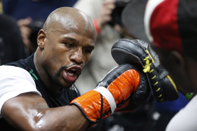 Boxer Floyd Mayweather Jr., left, works out with his uncle Roger Mayweather Tuesday, April 14, 2015, in Las Vegas. Mayweather will face Manny Pacquiao in a welterweight boxing match in Las Vegas on May 2. (AP Photo/John Locher)