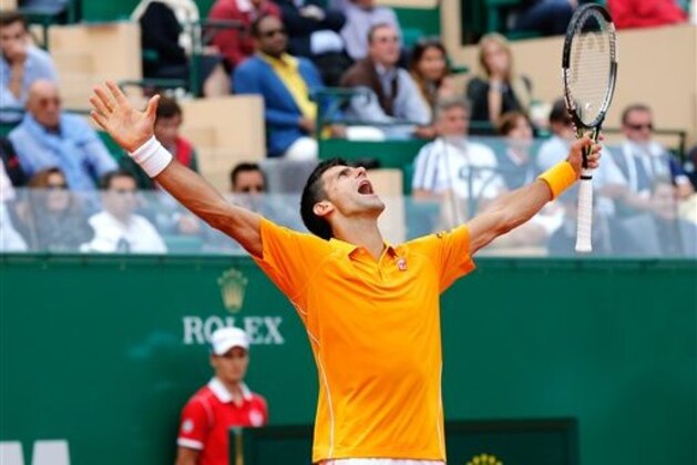Novak Djokovic of Serbia celebrates after defeating Rafael Nadal of Spain, during their semifinal match of the Monte Carlo Tennis Masters tournament,  in Monaco, Saturday, April, 18, 2015. (AP Photo/Claude Paris)