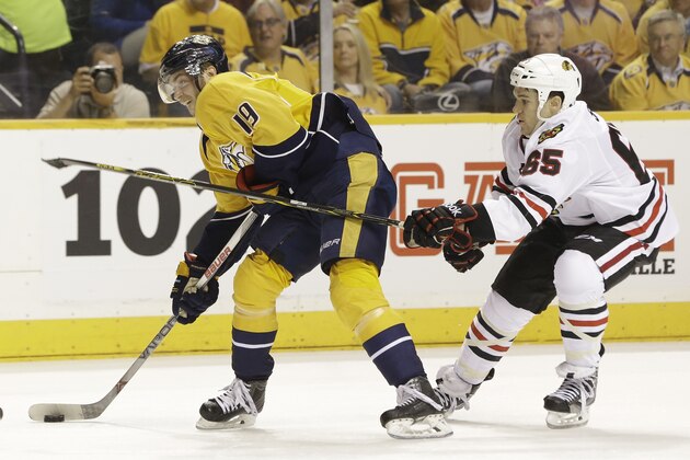 Chicago Blackhawks center Andrew Shaw (65) tries to slow down Nashville Predators center Calle Jarnkrok (19), of Sweden, in the third period of Game 1 of an NHL Western Conference hockey playoff series Wednesday, April 15, 2015, in Nashville, Tenn. (AP Photo/Mark Humphrey)