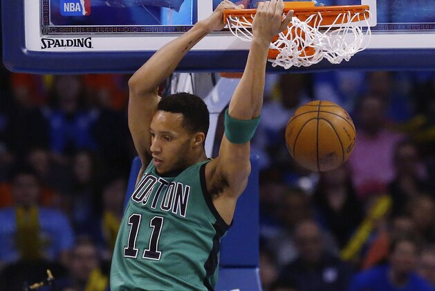 Boston Celtics guard Evan Turner (11) dunks in the first quarter of an NBA basketball game against the Oklahoma City Thunder in Oklahoma City, Wednesday, March 18, 2015. (AP Photo/Sue Ogrocki)