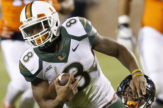 Miami running back Duke Johnson (8) is stopped by Virginia safety Wilfred Wahee (28) during the first half of an NCAA college football game in Charlottesville, Va., Saturday, Nov. 22, 2014. (AP Photo/Steve Helber)