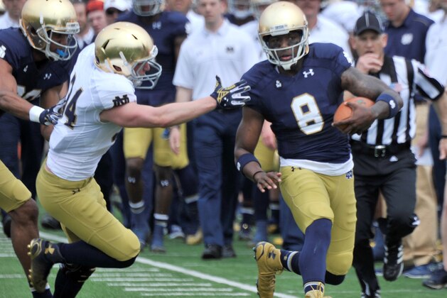 Notre Dame quarterback Malik Zaire (8) avoids being tackled by Jesse Bongiovi (34) during the Blue Gold spring NCAA college football game, Saturday April 18, 2015 in South Bend, Ind. (AP Photo/Joe Raymond)
