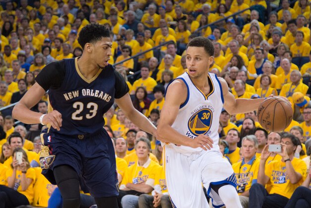 April 18, 2015; Oakland, CA, USA; Golden State Warriors guard Stephen Curry (30) dribbles the basketball against New Orleans Pelicans forward Anthony Davis (23) during the third quarter in game one of the first round of the NBA Playoffs at Oracle Arena. The Warriors defeated the Pelicans 106-99. Mandatory Credit: Kyle Terada-USA TODAY Sports