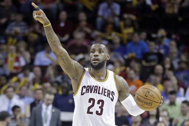 FILE - This Monday, April 13, 2015, file photo shows Cleveland Cavaliers' LeBron James signaling a play in an NBA basketball game against the Detroit Pistons in Cleveland. For James, his homecoming season with the Cavaliers went up, down and sometimes sideways, like three seasons rolled into one. The fourth is about to begin. The only one that matters. (AP Photo/Mark Duncan, File)