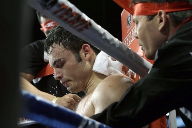 CORRECTS SPELLING OF FIRST NAME TO BRYAN - Julio Cesar Chavez Jr. sits in his corner after the sixth round of a 10-round boxing match between Chavez, the former World Boxing Council (WBC) middleweight champion, and Bryan Vera, the contender, in Carson, Calif., Saturday, Sept. 28, 2013. Chavez won in a unanimous decision. (AP Photo/Reed Saxon)
