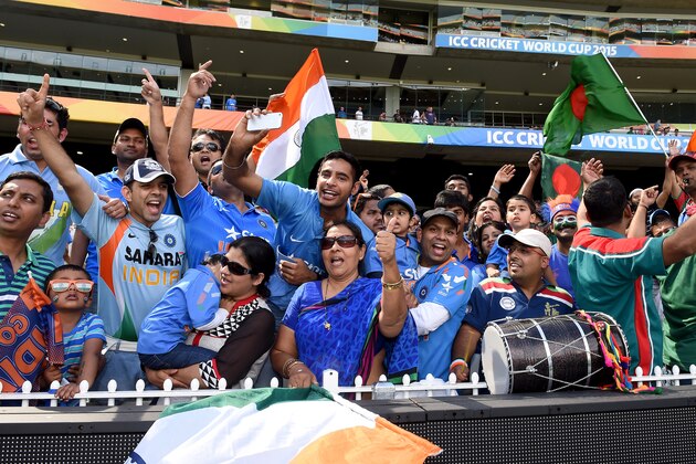 Indian and Bangladesh fans wave their flags and cheer their teams during the Cricket World Cup quarterfinal match in Melbourne, Australia, Thursday, March 19, 2015. (AP Photo/Andy Brownbill)