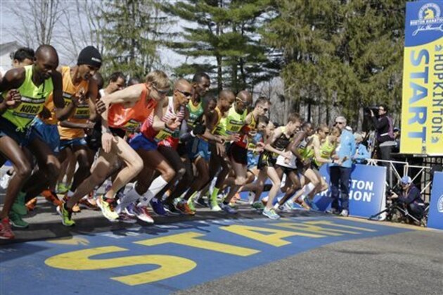 CORRECTS SPELLING OF WINNER'S LAST NAME TO KEFLEZIGHI INSTEAD OF KEFLIZIGHI - Elite men runners leave the start line in the 118th running of the Boston Marathon Monday, April 21, 2014, in Hopkinton, Mass. Fourth from left is eventual winner Meb Keflezighi. Third from left is Ryan Hall. (AP Photo/Stephan Savoia)