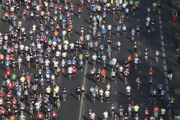 Runners make their way down the Champs Elysees avenue at the start of the 39th Paris Marathon in Paris, Sunday, April 12, 2015. (AP Photo/Thibault Camus)