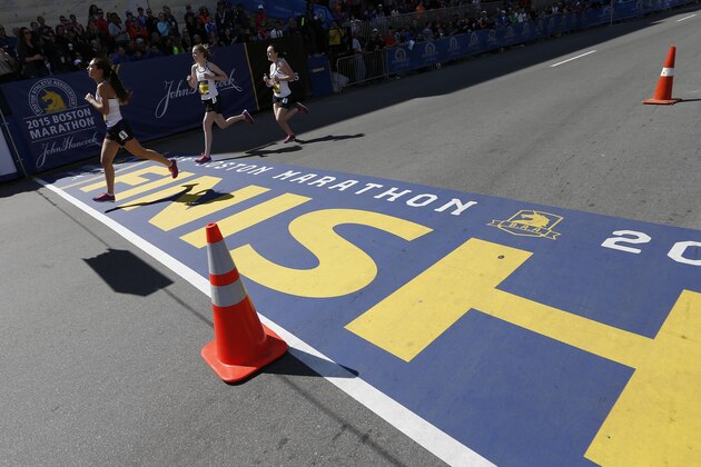 Runners in the girls scholastic mile compete as part of Boston Marathon weekend activities in Boston, Saturday, April 18, 2015. The 119th Boston Marathon will be run on Monday. (AP Photo/Michael Dwyer)