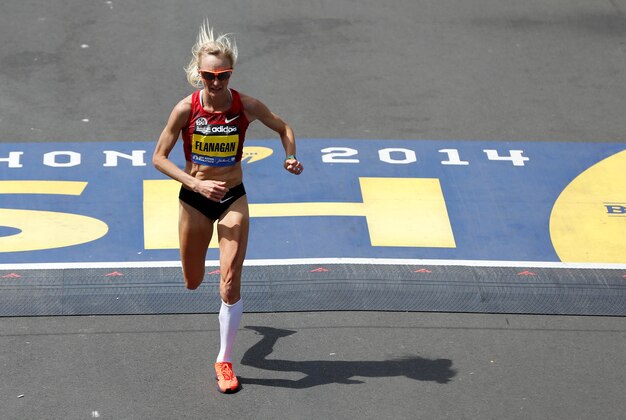 Apr 21, 2014; Boston, MA, USA; Shalane Flanagan (USA) crosses the finish line during the 2014 Boston Marathon. Mandatory Credit: Greg M. Cooper-USA TODAY Sports