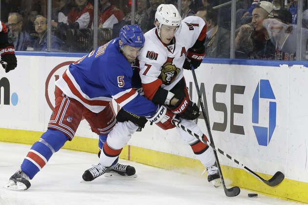 New York Rangers defenseman Dan Girardi (5) and Ottawa Senators center Kyle Turris (7) during the first period of an NHL hockey game, Thursday, April 9, 2015, at Madison Square Garden in New York. The Senators won 3-0. (AP Photo/Mary Altaffer)