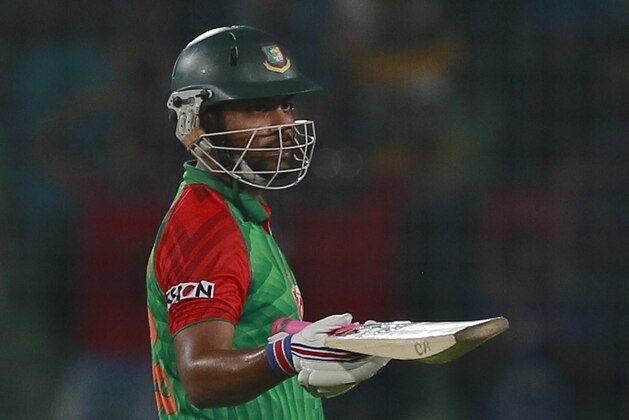 Bangladesh’s Tamim Iqbal acknowledges the crowd after scoring fifty runs during the second one-day international cricket match against Pakistan in Dhaka, Bangladesh, Sunday, April 19, 2015. (AP Photo/ A.M. Ahad)