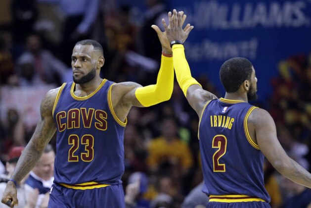 Cleveland Cavaliers' LeBron James (23) and Kyrie Irving (2) celebrate during an NBA basketball game against the Miami Heat Thursday, April 2, 2015, in Cleveland. (AP Photo/Tony Dejak)