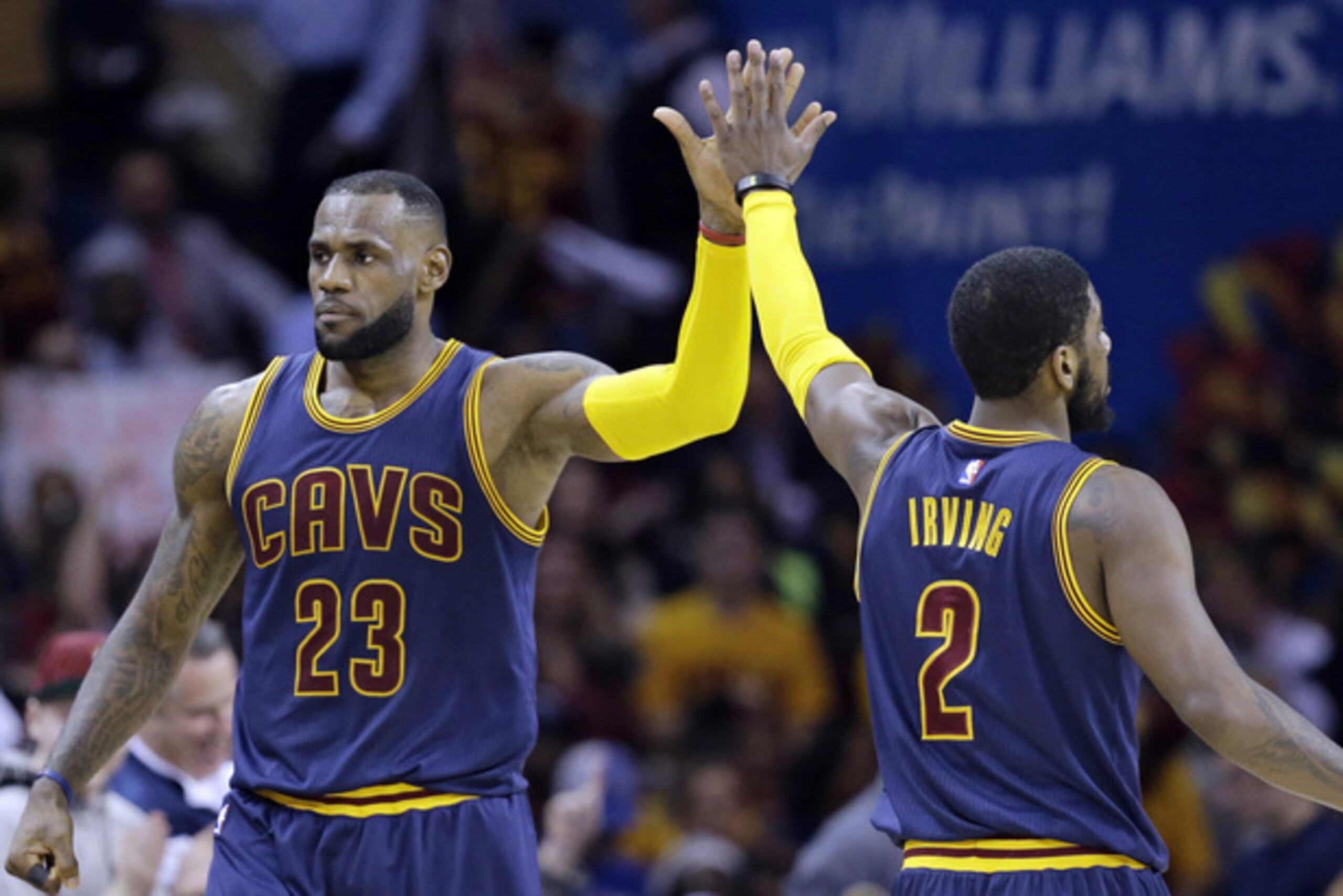 Cleveland Cavaliers' LeBron James (23) and Kyrie Irving (2) celebrate during an NBA basketball game against the Miami Heat Thursday, April 2, 2015, in Cleveland. (AP Photo/Tony Dejak)