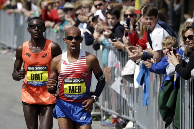 Josphat Boit, left, and Meb Keflezighi, compete along the course of the 118th Boston Marathon Monday, April 21, 2014 en route to Boston. (AP Photo/Steven Senne)