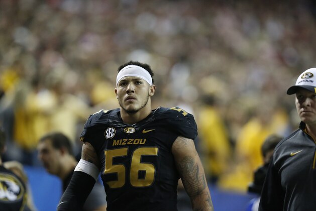 Missouri defensive lineman Shane Ray (56) walks off the field after being ejected from the game for a late hit against Alabama quarterback Blake Sims during the first half of the Southeastern Conference championship NCAA college football game, Saturday, Dec. 6, 2014, in Atlanta. (AP Photo/Brynn Anderson)
