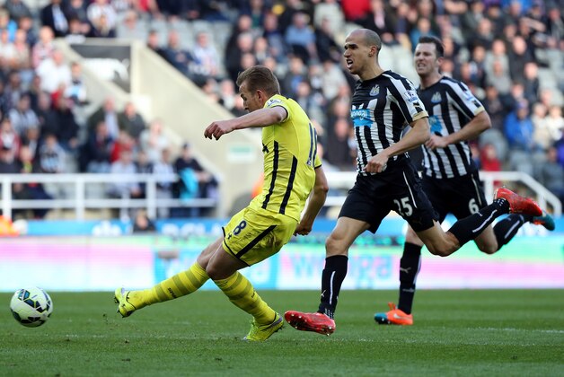 Tottenham Hotspur's Harry Kane, left, scores his goal Newcastle United's Gabriel Obertan, right,  during their English Premier League soccer match between Newcastle United and Tottenham Hotspur at St James' Park, Newcastle, England, Sunday, April, 19, 2015. (AP Photo/Scott Heppell)