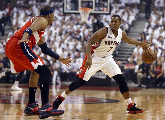 Apr 18, 2015; Toronto, Ontario, CAN; Toronto Raptors guard Kyle Lowry (7) keeps the ball away from Washington Wizards forward Paul Pierce (34) during the first half in game one of the first round of the NBA Playoffs at Air Canada Centre. Mandatory Credit: John E. Sokolowski-USA TODAY Sports