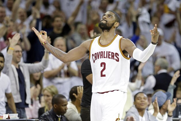 Cleveland Cavaliers' Kyrie Irving celebrates after making a 3-point shot at the buzzer to end the second quarter of a first round NBA playoff basketball game against the Cleveland Cavaliers Sunday, April 19, 2015, in Cleveland. (AP Photo/Mark Duncan)