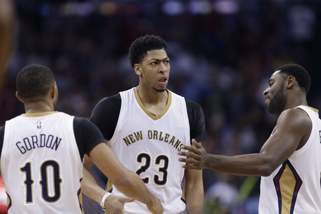 New Orleans Pelicans forward Anthony Davis (23) facts with guard Eric Gordon (10) and guard Tyreke Evans (1) in the second half of an NBA basketball game against the Golden State Warriors in New Orleans, Tuesday, April 7, 2015. The Pelicans won 103-100. (AP Photo/Gerald Herbert)