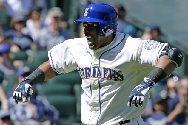 Seattle Mariners' Nelson Cruz celebrates after crossing the plate after he hit a solo home run against the Texas Rangers in the first inning of a baseball game, Sunday, April 19, 2015, in Seattle. (AP Photo/Ted S. Warren)