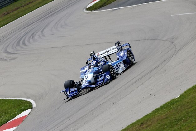 Scott Dixon, of New Zealand, (9) drives during a practice round for the IndyCar Grand Prix of Louisiana auto race, Saturday, April 11, 2015, in Avondale, La. (AP Photo/Jonathan Bachman)