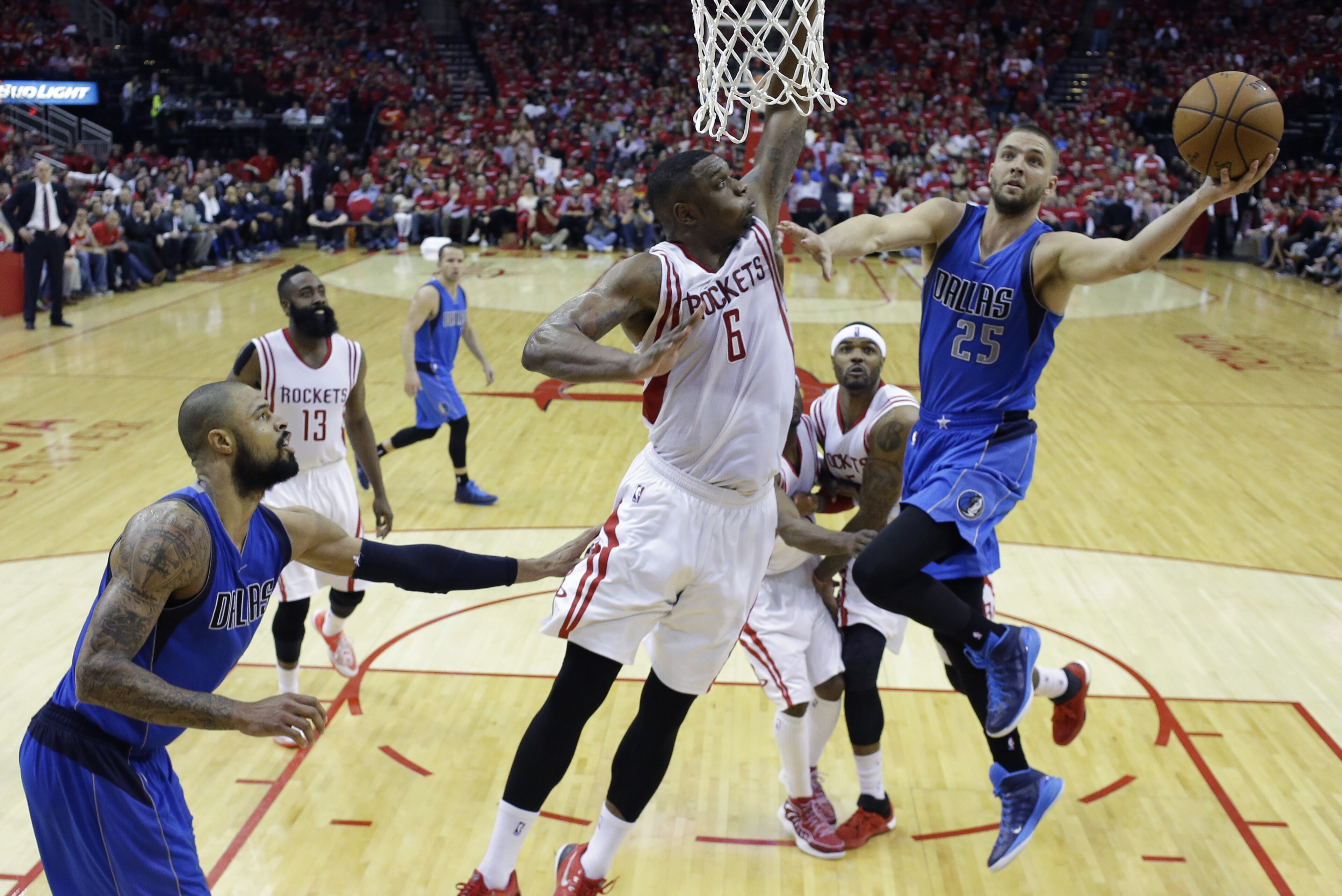 Dallas Mavericks' Chandler Parsons (25) drives to the basket over Houston Rockets' Terrence Jones (6) during the second half of game 1 in the first round of the NBA basketball playoffs Saturday, April 18, 2015, in Houston. Houston won 118-108. (AP Photo/David J. Phillip)