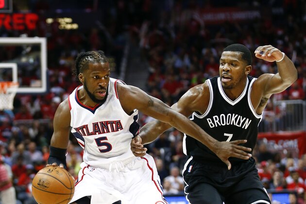 Atlanta Hawks forward DeMarre Carroll (5) drives against Brooklyn Nets forward Joe Johnson (7) in the first half of an NBA playoff basketball game  Sunday, April 19, 2015, in Atlanta.  (AP Photo/John Bazemore)