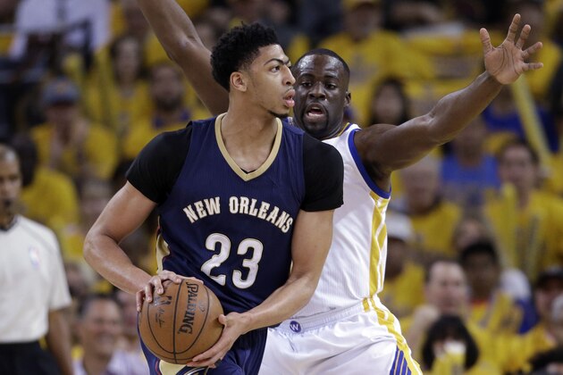 Golden State Warriors' Draymond Green, right, defends on New Orleans Pelicans' Anthony Davis (23) during the first half in Game 1 of the NBA basketball playoffs Saturday, April 18, 2015, in Oakland, Calif. (AP Photo/Marcio Jose Sanchez)
