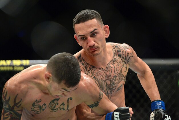 Apr 18, 2015; Newark, NJ, USA; Cub Swanson (red) and Max Holloway (blue) fight during UFC Fight Night at Prudential Center. Holloway won via third round tap out. Mandatory Credit: Joe Camporeale-USA TODAY Sports