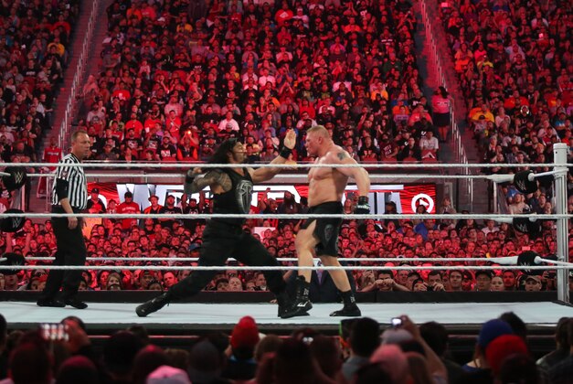 WWE wrestler Roman Reigns throws a punch at Brock Lesnar at Wrestlemania XXXI, on Sunday, March 29, 2015 in Santa Clara, CA. 2015 marks the first year Wrestlemania will be held in the San Francisco Bay Area, being made available to viewers in 177 countries via the WWE Network. (Don Feria/AP Images for WWE)
