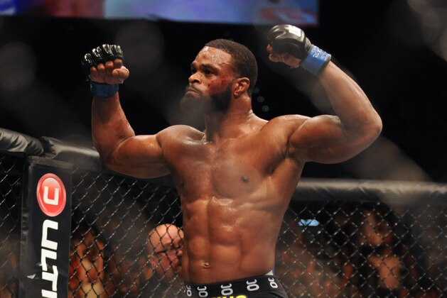 Nov 16, 2013; Las Vegas, NV, USA; Tyron Woodley (blue gloves) celebrates after defeating Josh Koscheck (red gloves) in their welterweight bout during UFC 167 at MGM Grand Garden Arena. Mandatory Credit: Stephen R. Sylvanie-USA TODAY Sports
