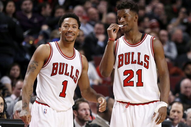 Chicago Bulls guard Derrick Rose (1) and Jimmy Butler (21) talk during the second half of an NBA basketball game against the Milwaukee Bucks, Monday, Feb. 23, 2015, in Chicago. The Bulls won 87-71. (AP Photo/Charles Rex Arbogast)