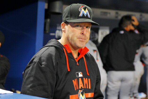 Miami Marlins manager Mike Redmond (11) looks on at the completion of the eighth inning of a baseball game against the Atlanta Braves Monday, April 13, 2015, in Atlanta. (AP Photo/Todd Kirkland)
