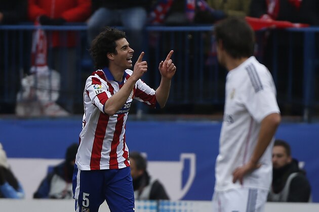 Atletico's Tiago, left, celebrates his goal during a Spanish La Liga soccer match between Atletico Madrid and Real Madrid at the Vicente Calderon stadium in Madrid, Spain, Saturday, Feb. 7, 2015. (AP Photo/Andres Kudacki)