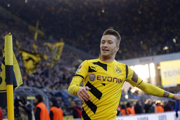 Dortmund's Marco Reus celebrates after scoring  during the German first division Bundesliga soccer match between BvB Borussia Dortmund  and Schalke 04 in Dortmund, Germany, Saturday, Feb. 28, 2015. (AP Photo/Frank Augstein)