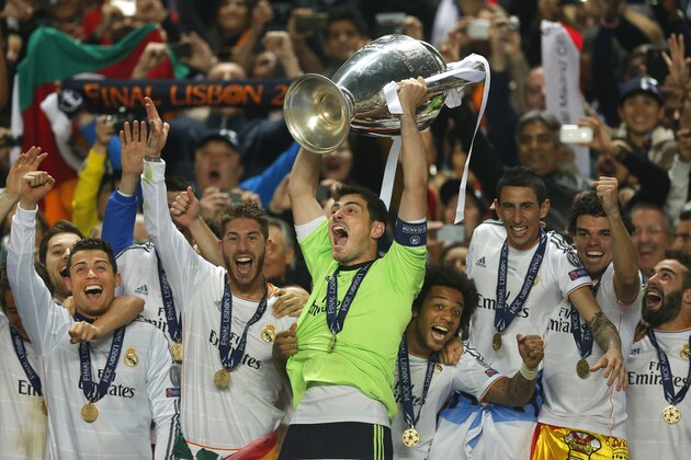 FOR USE AS DESIRED, YEAR END PHOTOS - FILE - Real goalkeeper Iker Casillas, center, lifts the Champion League trophy, as he and teammates, celebrate winning the Champion League title, against Atletico Madrid, in Lisbon, Portugal, Saturday, May 24, 2014.  (AP Photo/Andres Kudacki, File)