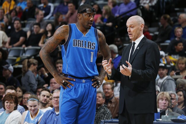 Dallas Mavericks center Amar'e Stoudemire (1), left, confers with Dallas Mavericks head coach Rick Carlisle during a timeout against the Denver Nuggets in the first quarter of an NBA basketball game Friday, April 10, 2015, in Denver. (AP Photo/David Zalubowski)