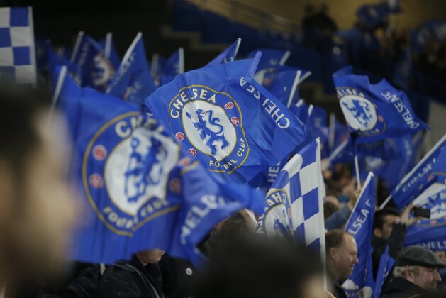 Fans of Chelsea cheer their team in the stands by waving flags prior to the Champions League round of 16 second leg soccer match between Chelsea and Paris Saint Germain at Stamford Bridge stadium in London, Wednesday, March, 11, 2015. (AP Photo/Alastair Grant)