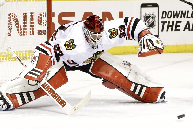 Chicago Blackhawks goalie Scott Darling reaches for the puck in the third period of Game 1 of an NHL Western Conference hockey playoff series against the Nashville Predators Wednesday, April 15, 2015, in Nashville, Tenn. (AP Photo/Mark Humphrey)