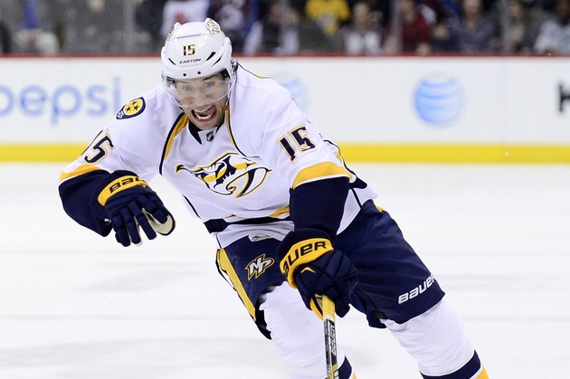 Apr 7, 2015; Denver, CO, USA; Nashville Predators center Craig Smith (15) controls the puck in the first period against the Colorado Avalanche at Pepsi Center. Mandatory Credit: Ron Chenoy-USA TODAY Sports