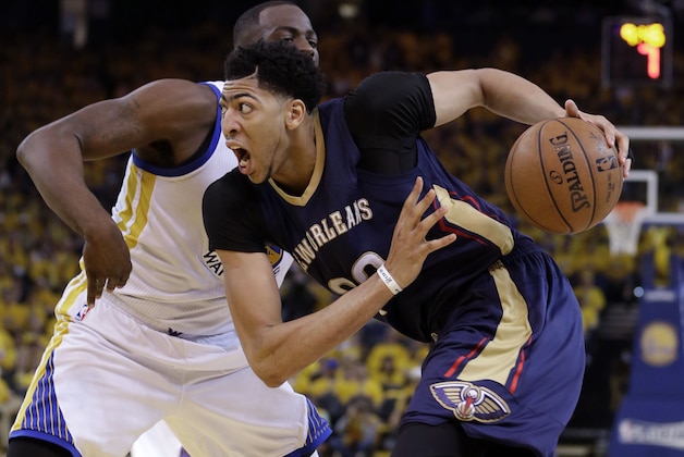 New Orleans Pelicans' Anthony Davis, right, drives past Golden State Warriors' Draymond Green during the second half in Game 1 of the NBA basketball playoffs Saturday, April 18, 2015, in Oakland, Calif. Golden State won 106-99. (AP Photo/Marcio Jose Sanchez)