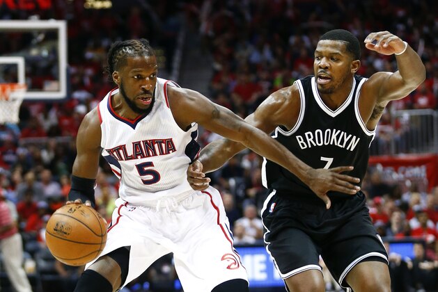 Atlanta Hawks forward DeMarre Carroll (5) drives against Brooklyn Nets forward Joe Johnson (7) in the first half of an NBA playoff basketball game  Sunday, April 19, 2015, in Atlanta.  (AP Photo/John Bazemore)