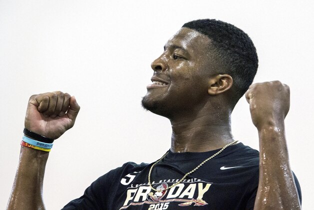 Jameis Winston pumps his fists after a pass competition during Florida State football pro day in Tallahassee, Fla., Tuesday, March 31, 2015.  (AP Photo/Mark Wallheiser)