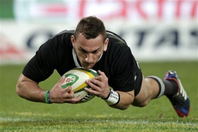 New Zealand's Aaron Cruden scores a try after gathering a ball he blocked a kick from Australia during their Bledisloe Cup rugby union match at the Olympic Stadium in Sydney, Australia, Saturday, Aug. 17, 2013.  (AP Photo/Rick Rycroft)