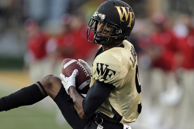 Wake Forest's Kevin Johnson intercepts a North Carolina State pass in the second half of an NCAA college football game in Winston-Salem, N.C., Saturday, Oct. 5, 2013. Wake Forest won 28-13. (AP Photo/Chuck Burton)